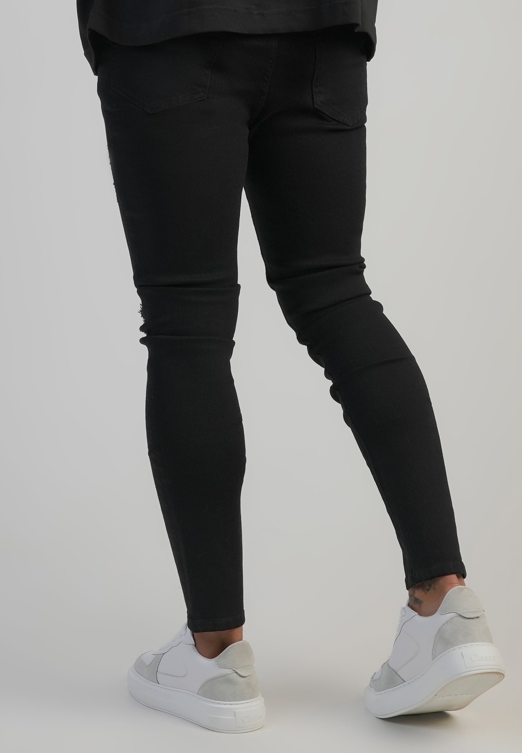 Distressed Skinny Jeans in Black Jeans SikSilk